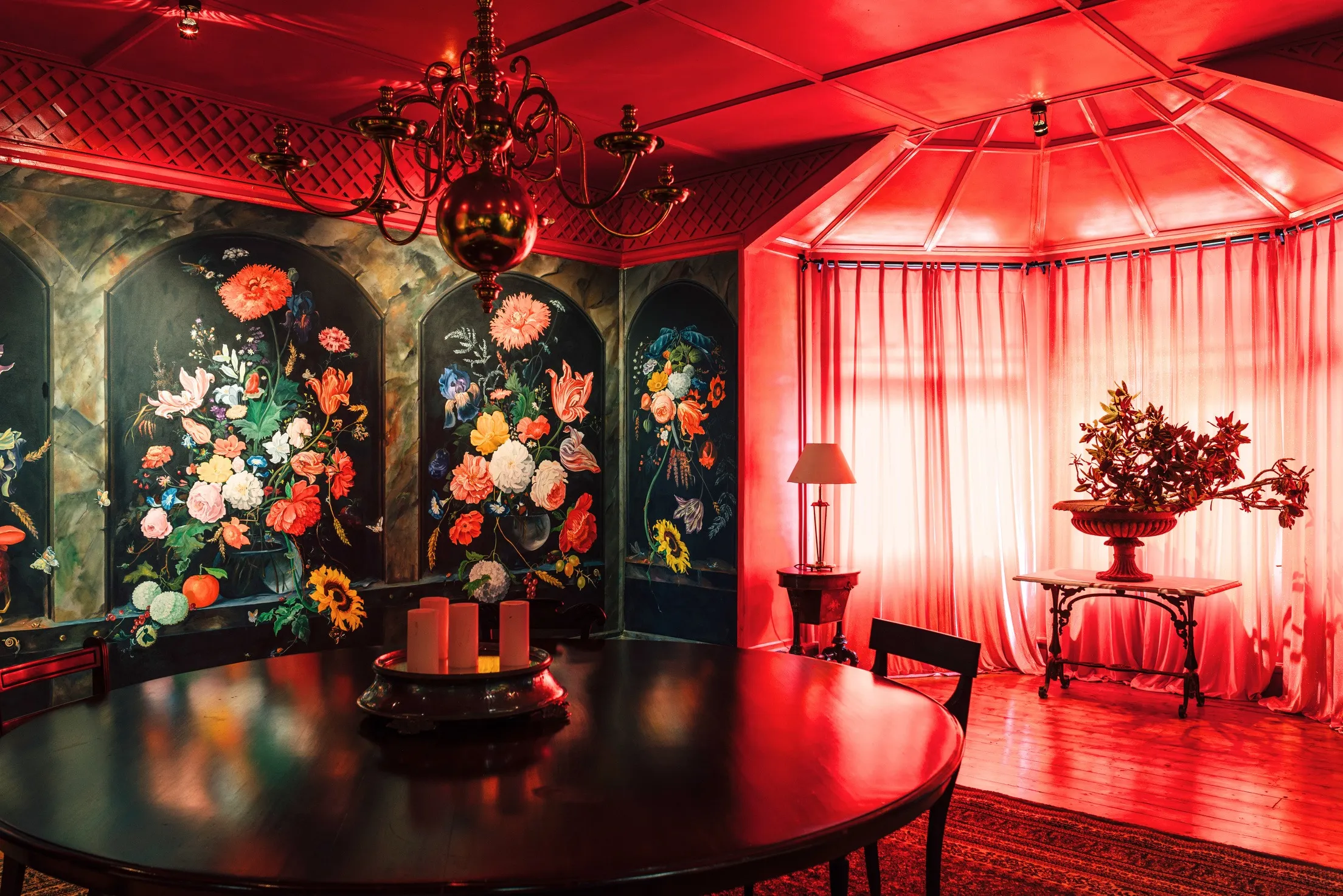 The red dining room with painted floral panels.
